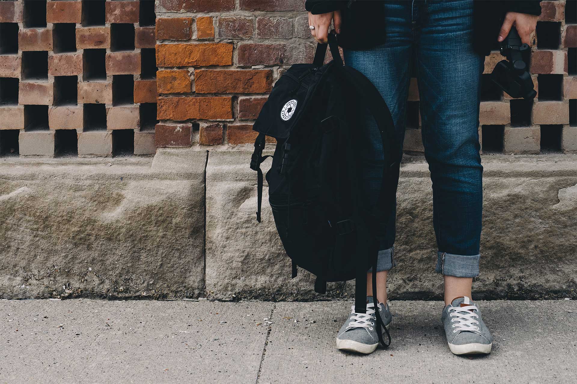 Image of student holding a book bag